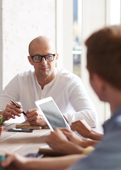Group of people in a meeting with tablets and smartphones