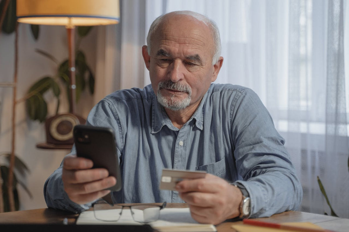man paying for cancer test on phone with credit card