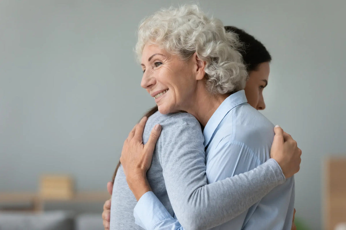 Grandmother and daughter hugging