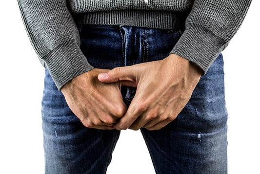 Man performing a self-examination for testicular health