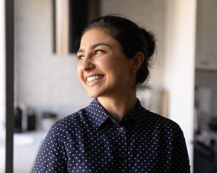 Mid 20s woman smiling after cancer all-clear test