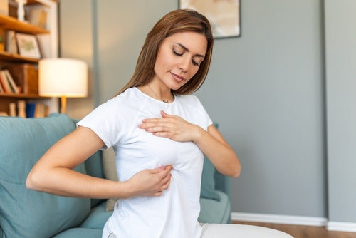 woman checking for breast lumps 