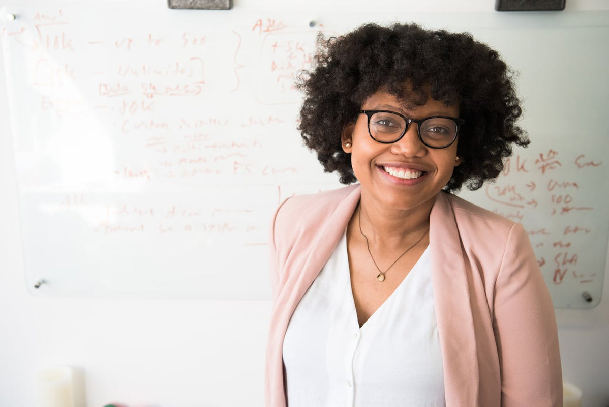 Consultant smiling against whiteboard